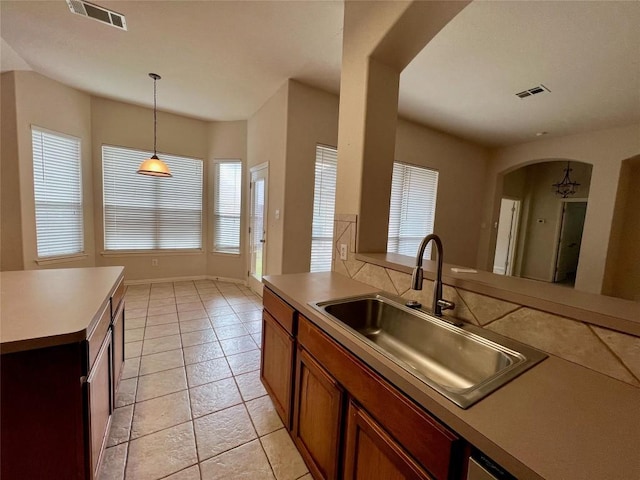 kitchen featuring pendant lighting, light tile patterned flooring, and sink