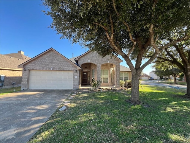 view of front of home with a front yard and a garage