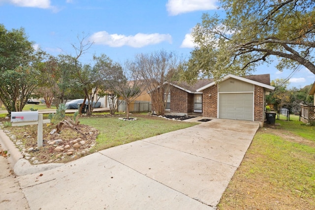 view of front of property featuring an attached garage, brick siding, fence, driveway, and a front lawn