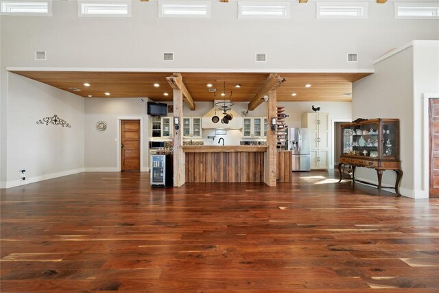 1440 W Klein Rd, New Braunfels, TX 78130 - living area with dark wood-style floors, wine cooler, recessed lighting, and a wood ceiling with exposed beams