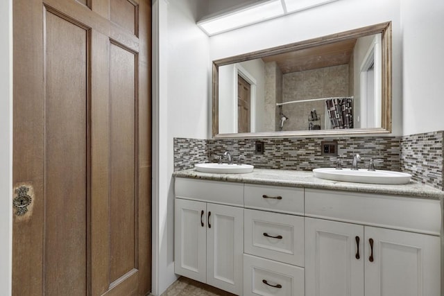 bathroom with a shower with curtain, decorative backsplash, and vanity