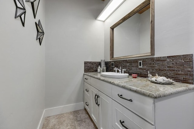 bathroom with decorative backsplash and vanity