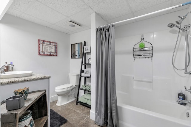 full bathroom featuring vanity, shower / bath combo, a paneled ceiling, and toilet