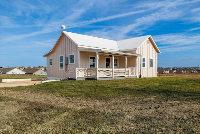 view of front of home with a porch and a front lawn