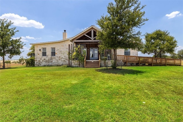 rear view of property with a lawn