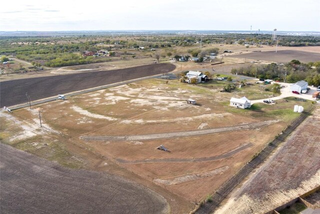 birds eye view of property with a rural view