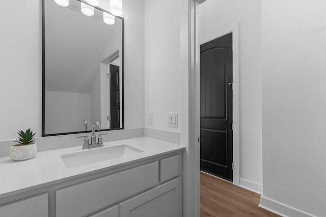 bathroom featuring vanity and hardwood / wood-style floors