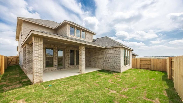 1024 Lariat Loop, Liberty Hill, TX 78642 - rear view of house featuring brick siding, a patio area, and a shingled roof