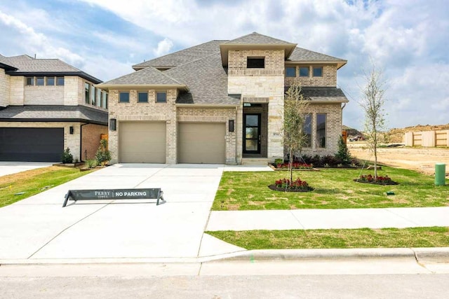1024 Lariat Loop, Liberty Hill, TX 78642 - view of front of house featuring brick siding, driveway, a front yard, and roof with shingles