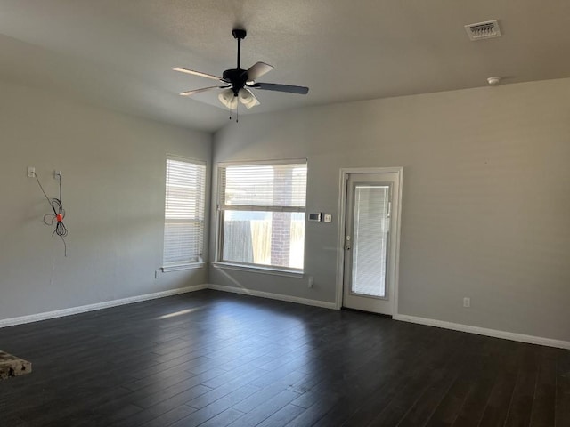 unfurnished room featuring ceiling fan, lofted ceiling, and dark wood-type flooring