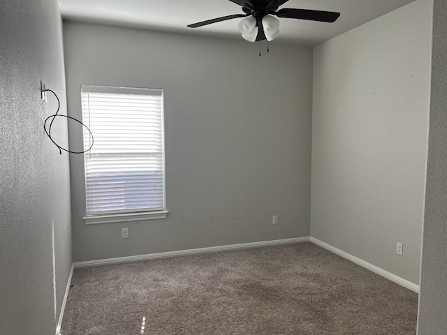 spare room featuring carpet and ceiling fan