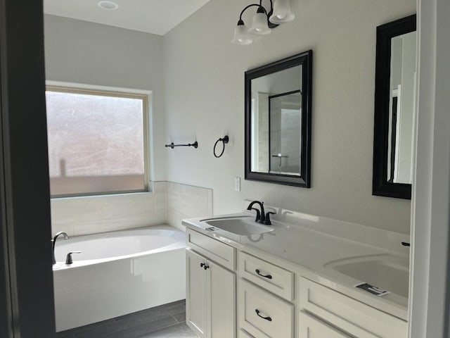 bathroom featuring vanity and a tub to relax in