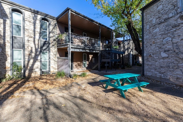 5820 Berkman Dr Unit 116, Austin, TX 78723 - back of house with stone siding, stairs, and a wooden deck