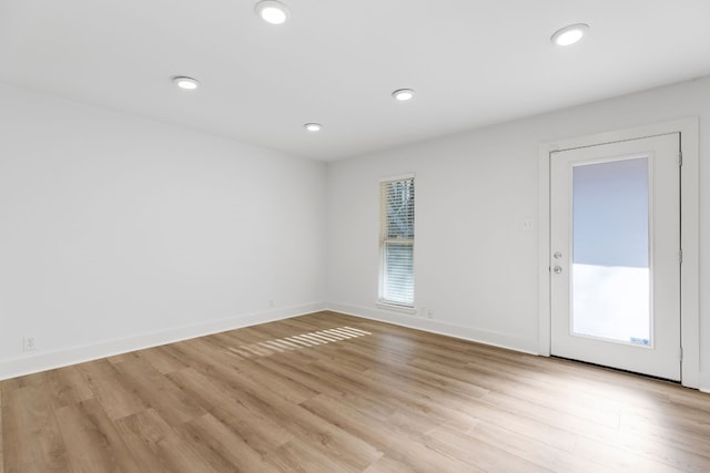 empty room with light hardwood / wood-style flooring