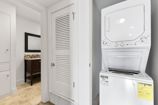 laundry area with stacked washer and dryer