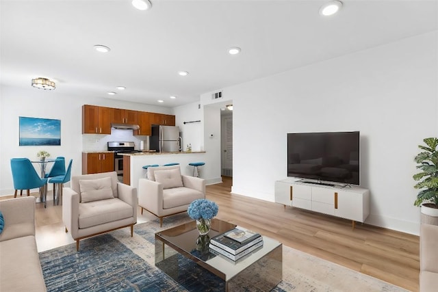 living room with light hardwood / wood-style flooring