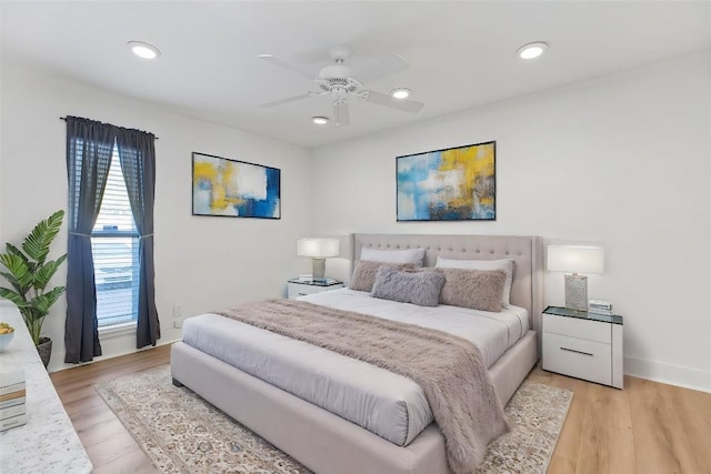 bedroom with ceiling fan and light hardwood / wood-style floors