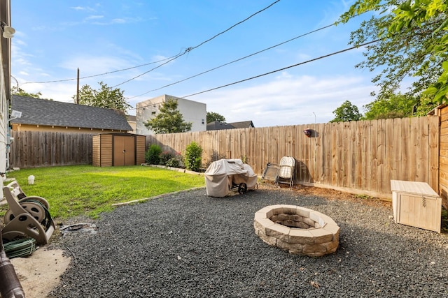 view of yard with a fire pit and a storage shed