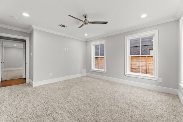 carpeted spare room with ceiling fan and crown molding