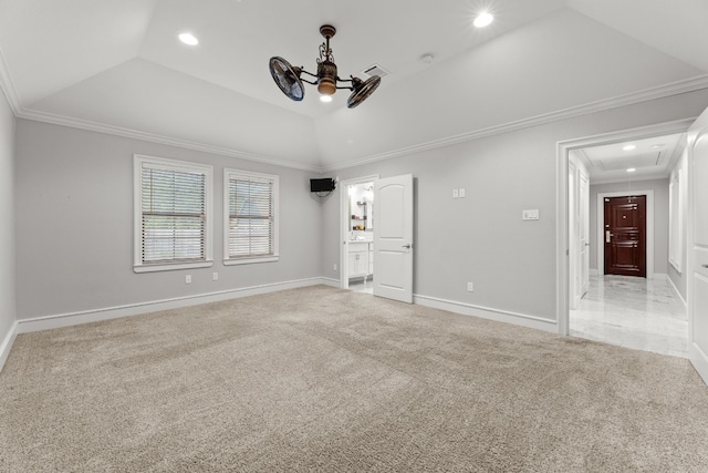 unfurnished room featuring lofted ceiling, crown molding, ceiling fan, a tray ceiling, and light colored carpet