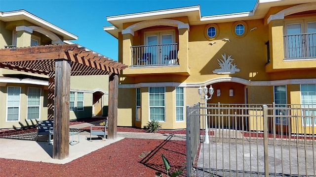 rear view of house with a pergola and a patio