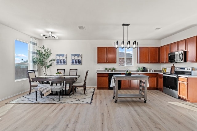 kitchen featuring stainless steel electric stove, decorative light fixtures, a chandelier, black dishwasher, and light hardwood / wood-style floors