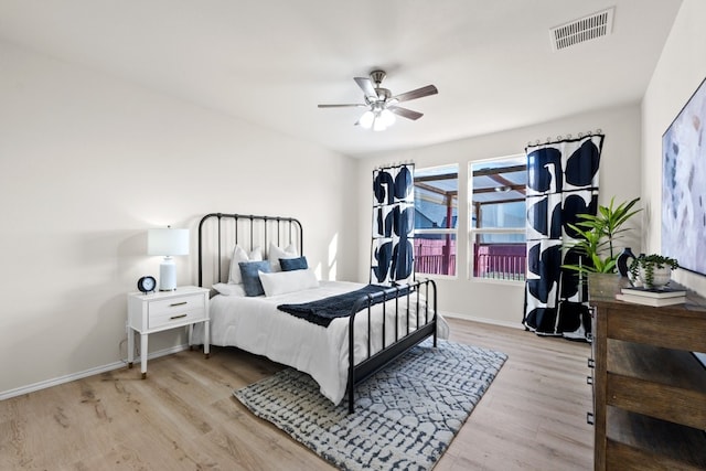 bedroom with ceiling fan and light hardwood / wood-style floors