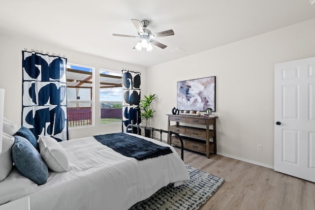 bedroom with light hardwood / wood-style floors and ceiling fan