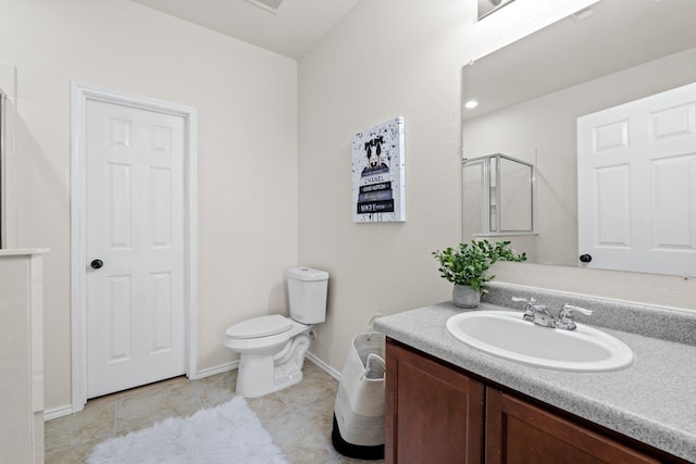 bathroom featuring tile patterned floors, a shower with door, vanity, and toilet