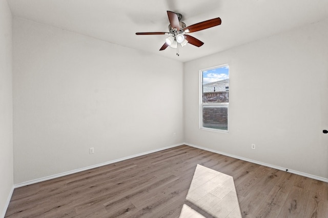 empty room featuring light wood-type flooring and ceiling fan