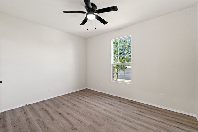 empty room with ceiling fan and light hardwood / wood-style floors