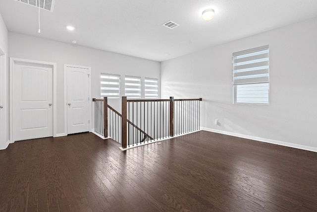 spare room with dark hardwood / wood-style floors