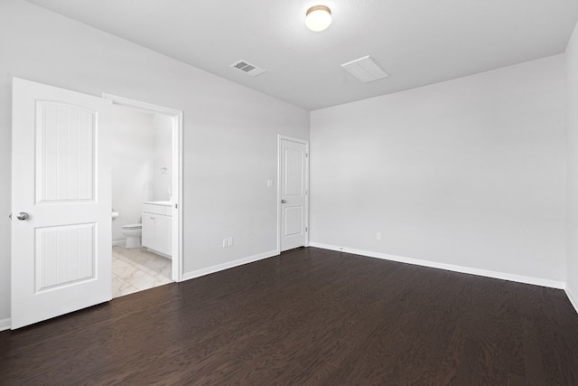 unfurnished bedroom featuring connected bathroom and light hardwood / wood-style floors