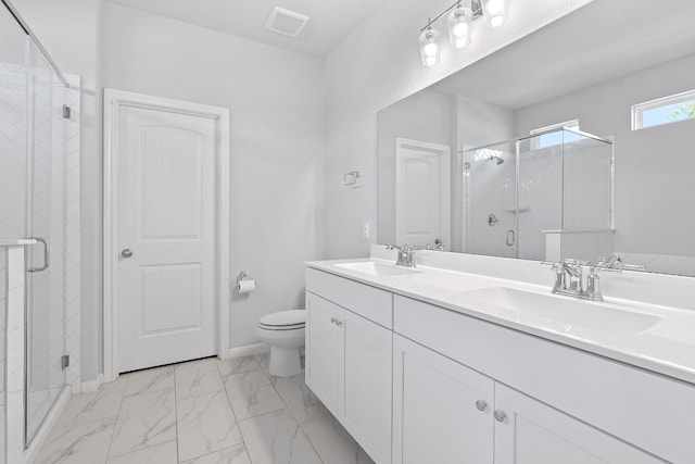 bathroom with walk in shower, vanity, and toilet