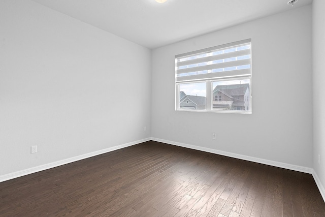 empty room with dark wood-type flooring