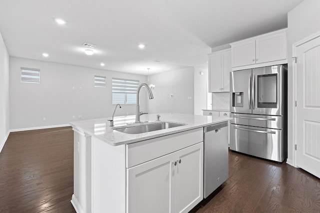 kitchen featuring a kitchen island with sink, sink, white cabinets, and appliances with stainless steel finishes