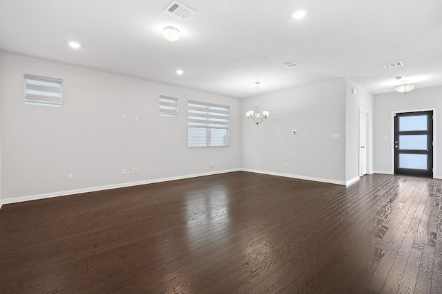 interior space featuring dark hardwood / wood-style flooring and a chandelier