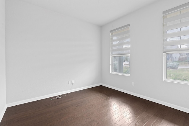 unfurnished room with dark hardwood / wood-style floors