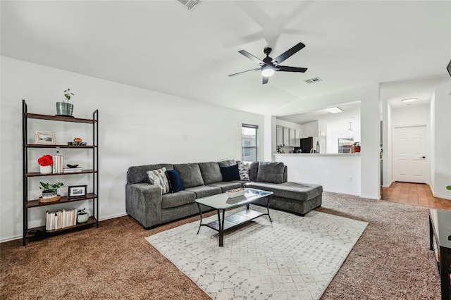 carpeted living room featuring ceiling fan