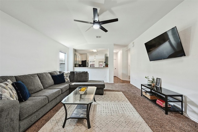 carpeted living room with ceiling fan