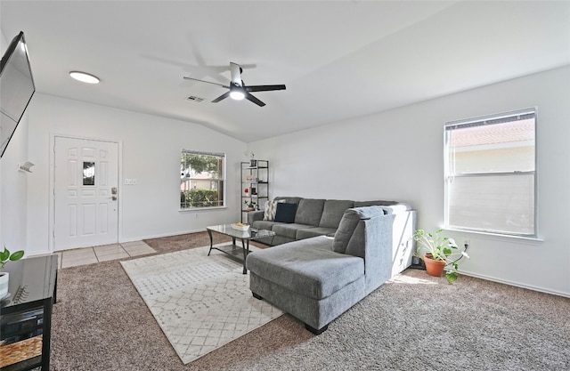 living room with ceiling fan, carpet floors, and lofted ceiling