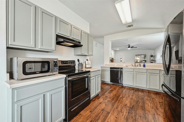 kitchen with sink, vaulted ceiling, ceiling fan, dark hardwood / wood-style flooring, and stainless steel appliances