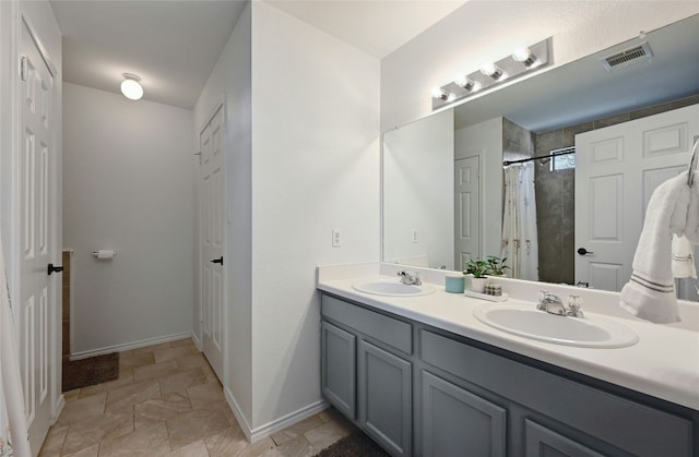 bathroom with vanity and curtained shower