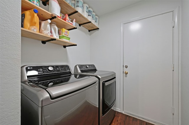 laundry room featuring washer and clothes dryer and dark wood-type flooring