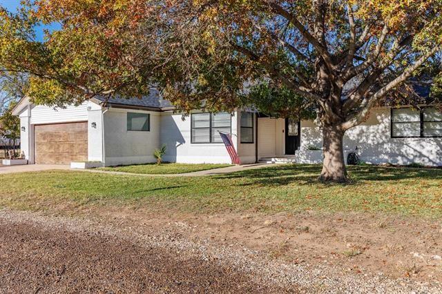 obstructed view of property with a front lawn and a garage