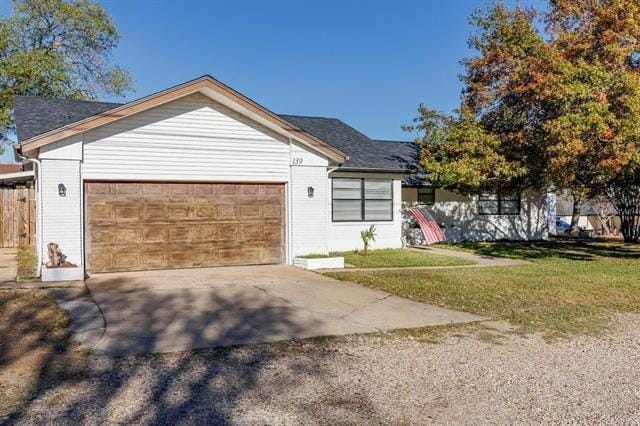 view of front of home with a garage and a front lawn