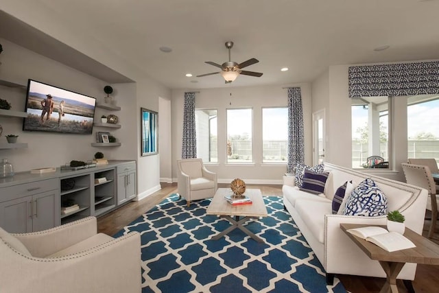 living room with hardwood / wood-style flooring and ceiling fan