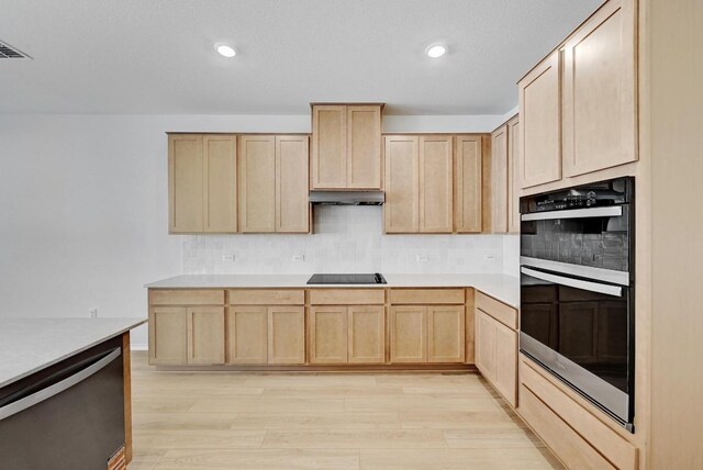 8004 Tranquil Glade Trl, Austin, TX 78744 - kitchen with light brown cabinetry, double oven, black electric cooktop, dishwasher, and recessed lighting