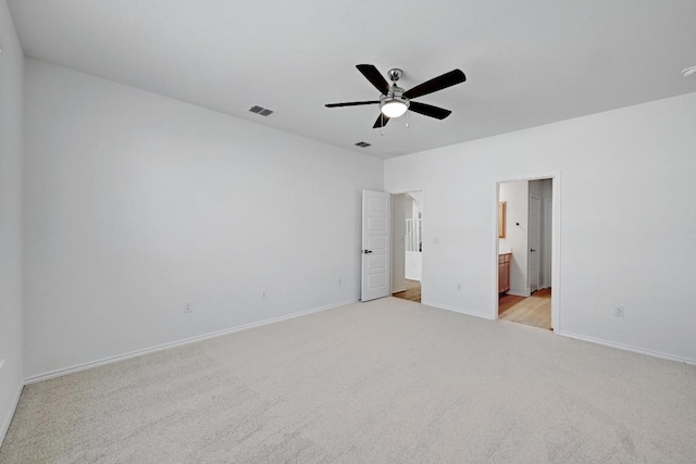 8004 Tranquil Glade Trl, Austin, TX 78744 - unfurnished bedroom featuring light carpet, baseboards, ensuite bathroom, and a ceiling fan
