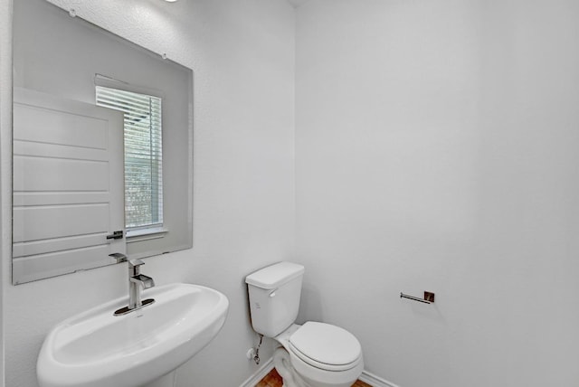 8004 Tranquil Glade Trl, Austin, TX 78744 - bathroom with a sink, toilet, and baseboards